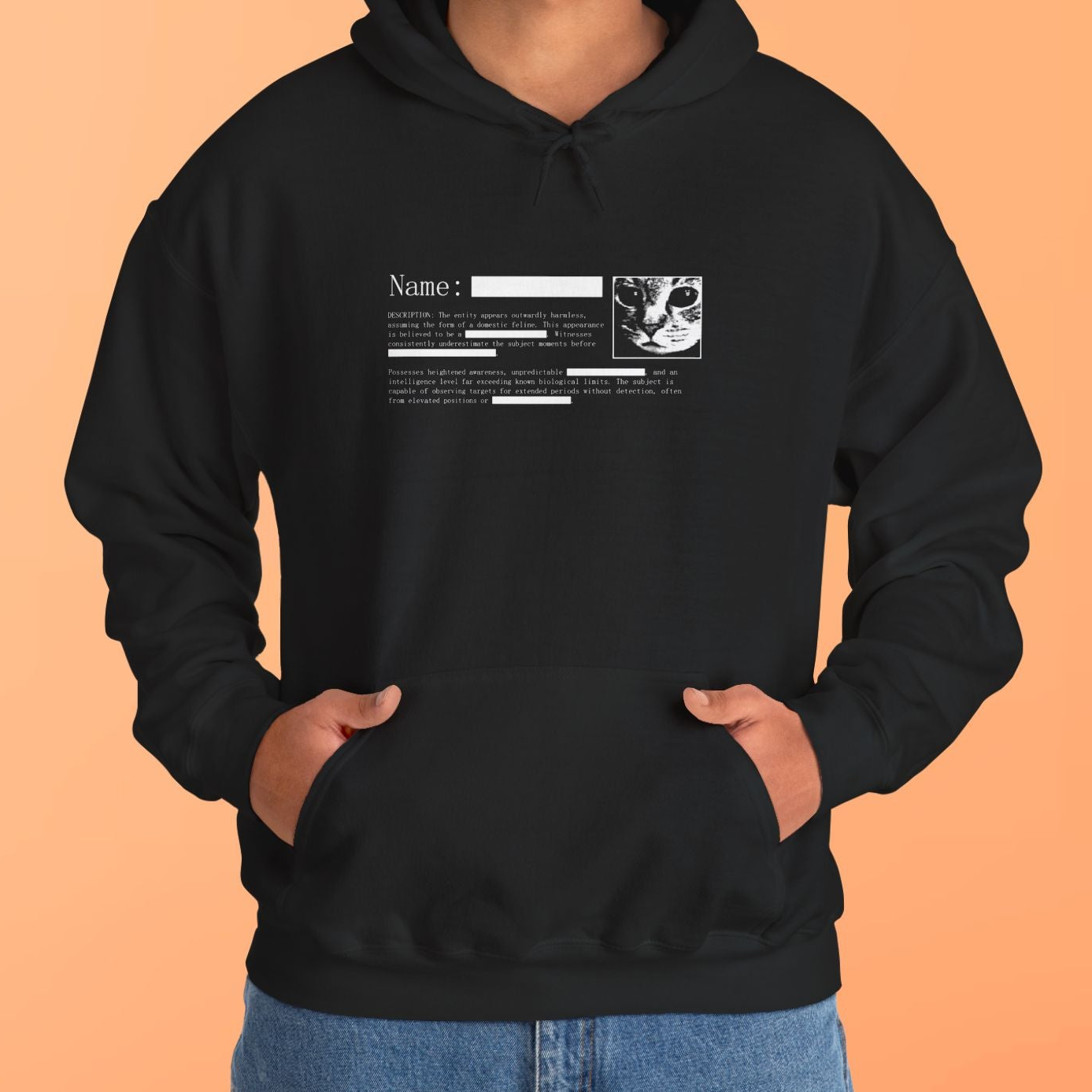 Person wearing a black hoodie with a graphic design on an orange background